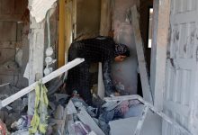 Palestinians in Gaza search through homes destroyed by Israeli strikes