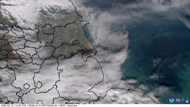 An oil tanker anchored near the Somali coast at dusk, with fishing villages in the background