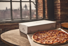 AI-generated image: A pizza sits on a wooden table.