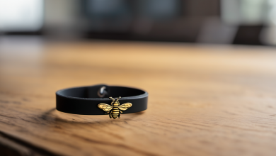 AI-generated image: A black bracelet with a gold bee charm is prominently displayed on a wooden surface.