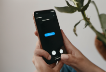 AI-generated image: A person's hand is holding a silver smartphone.