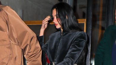 Dua Lipa wearing a cropped black velvet jacket with dark denim jeans and zebra-print pumps in NYC