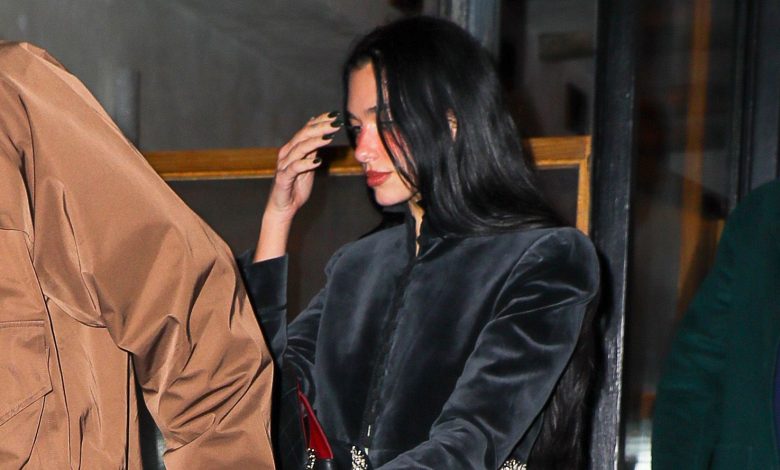 Dua Lipa wearing a cropped black velvet jacket with dark denim jeans and zebra-print pumps in NYC