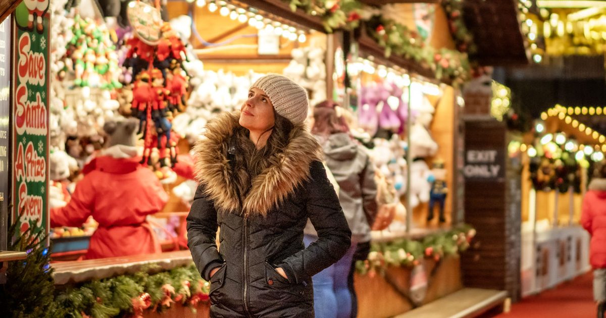 Lady browsing round a Christmas market stall