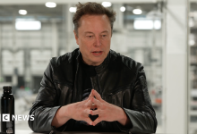 Elon Musk, in a black leather jacket, speaking about SpaceX's quarterly business performance in a livestream.