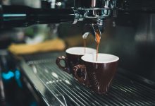 Close-up of espresso machine with two brown coffee cups.jpg