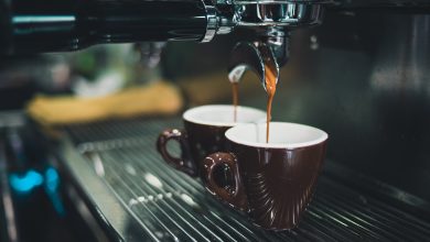 Close-up of espresso machine with two brown coffee cups.jpg
