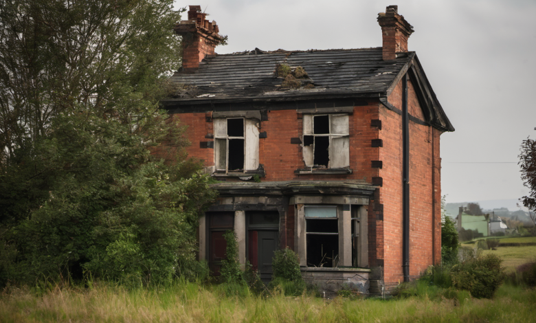 AI-generated image: A dilapidated, two-story brick house with a slate roof.