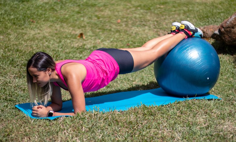 Girl exercising doing plank on stability ball.jpg