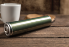 AI-generated image: A cylindrical, metallic object with a green and silver finish is the main subject.