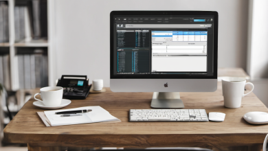 AI-generated image: A wooden desk with a silver Apple iMac computer, a white ceramic mug, a white notebook, a pen, a calculator, a mouse, and a smartphone are arranged on the desk.