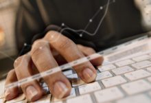 Person typing at keyboard with screen overlays.jpg