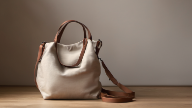 AI-generated image: A light beige tote bag with a rounded shape and a brown leather handle and strap is the main subject.