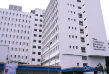Hospital corridor with medical scrubs and stethoscope on a desk