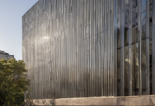 AI-generated image: A modern building with a facade composed of vertical, corrugated metal panels.