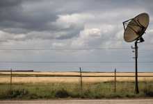 AI-generated image: A satellite dish is mounted on a pole in the foreground.