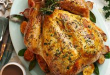 Next level roast turkey served on an oval dish with gravy alongside