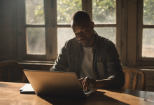 AI-generated image: A man is sitting at a wooden table, working on a laptop.