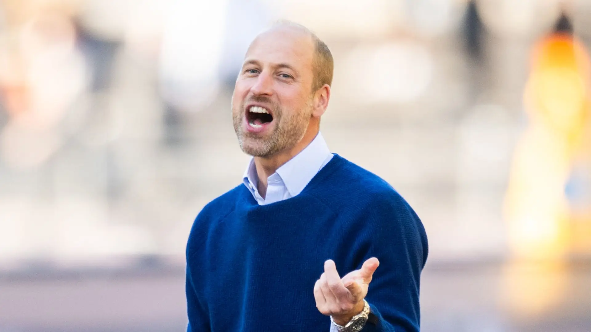 prince william in navy jumper pointing