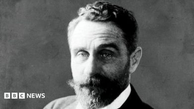 An archive image of Roger Casement in Black and white. He has a thick beard and moustache, and short wavy hair.