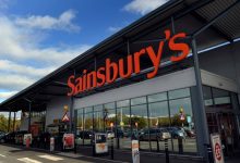 Exterior of a Sainsbury's supermarket with its orange sign above the entrance