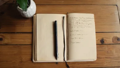 AI-generated image: A top-down photograph shows an open, worn leather-bound notebook lying on a wooden surface.