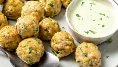 Platter of baked southwest turkey meatballs with bowl of creamy dipping sauce.