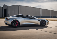 AI-generated image: A silver sports car with a convertible top is parked on an asphalt road.