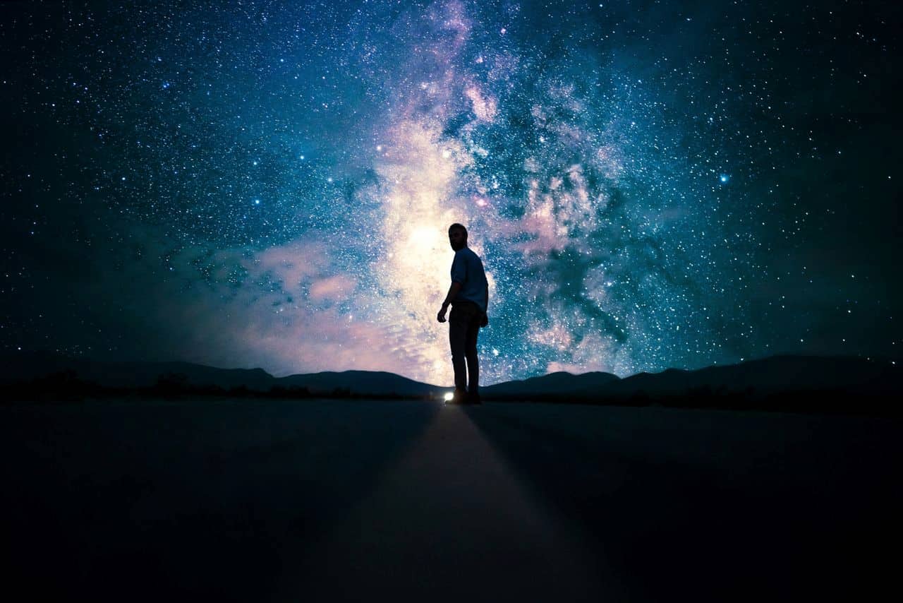 image of a man underneath the milky way symbolic of being an outsider