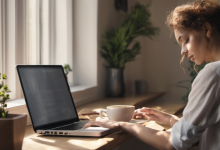 AI-generated image: A young woman with curly reddish-brown hair is sitting at a wooden table with a laptop and a mug.